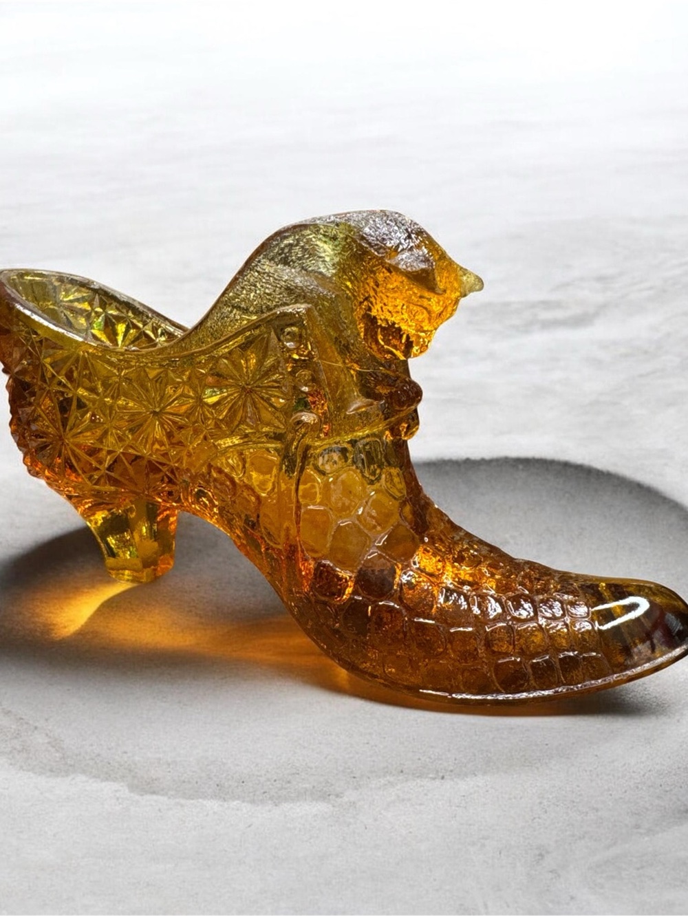 Vintage Fenton amber glass slipper featuring a cat head design.